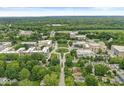 Aerial view of campus showcasing academic buildings surrounded by lush greenery and tree-lined streets at 518 Buckingham Dr, Indianapolis, IN 46208