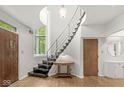 Bright foyer with an open staircase and curved ceiling above highlights the entryway's unique style at 518 Buckingham Dr, Indianapolis, IN 46208