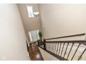 Grand foyer view from above showcases a high ceiling, hardwood floors, and a welcoming front door at 5767 Bluff View Ln, Whitestown, IN 46075