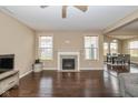 Open living room with fireplace, hardwood floors, and large windows offering ample natural light at 5767 Bluff View Ln, Whitestown, IN 46075