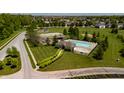 Aerial shot of community pool, playground, and gazebo amenities in a well-maintained green space at 6027 Bluecrest Dr, Brownsburg, IN 46234