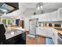 Well-lit kitchen features stainless steel appliances, white cabinetry and views of the dining area at 6933 Grey Wolf Dr, , IN 46164