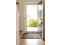 Welcoming entryway with hardwood floors, neutral walls, and a glimpse of the exterior at 7042 Gavin Dr, Indianapolis, IN 46217