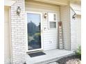 Inviting front door entrance with sidelight, decorative lighting, brick accents and welcoming decor at 7042 Gavin Dr, Indianapolis, IN 46217