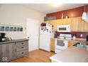 Well-lit kitchen with light wood cabinets, white appliances, and laminate countertops at 7042 Gavin Dr, Indianapolis, IN 46217