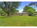 Charming home featuring a well-manicured lawn and mature tree in the front yard at 7061 Maryann Ct, Indianapolis, IN 46227