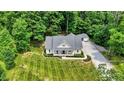 Scenic aerial shot of a property with a long driveway and a detached garage at 7074 E Pine Needle Ln, Morgantown, IN 46160