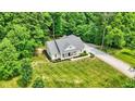 Aerial view of a well-maintained home showcasing the expansive yard and landscaping at 7074 E Pine Needle Ln, Morgantown, IN 46160