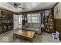 Cozy living room featuring wood paneled walls and a comfortable seating area at 719 Melvenia St, Indianapolis, IN 46219