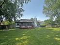 Spacious backyard with a wooden deck, screened-in porch, and fire pit at 723 Bennett Rd, Carmel, IN 46032