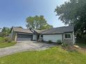 View of house with attached garage and well maintained front lawn at 723 Bennett Rd, Carmel, IN 46032
