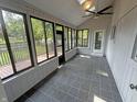 Cozy sunroom with tile flooring, ceiling fan and abundant natural light at 723 Bennett Rd, Carmel, IN 46032