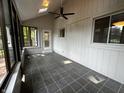 Inviting sunroom featuring tile flooring, bright windows, and a ceiling fan for year-round enjoyment at 723 Bennett Rd, Carmel, IN 46032