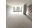Unfinished, open-concept living space with abundant natural light and staircase at 7305 Bayview Run # 13-605, McCordsville, IN 46055