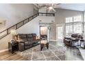 Spacious living room with a cozy couch, high ceilings, and access to upper level at 7803 Harbour, Indianapolis, IN 46240