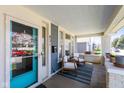 Inviting front porch with seating area, blue door, and great natural light at 831 Weghorst St, Indianapolis, IN 46203