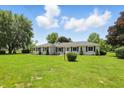 Attractive single-story home with a manicured lawn and tidy landscaping at 8510 N Carroll Rd, Indianapolis, IN 46236