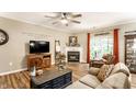 Inviting living room boasts a fireplace, hardwood floors, and relaxed seating arrangement at 9263 Wadsworth Ct, Fishers, IN 46037