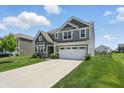Inviting two-story house featuring a long driveway and green lawn at 9537 Crossfield Rd, Avon, IN 46123