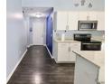 Bright kitchen with white cabinetry, granite countertops, and stainless steel appliances at 10628 Bali Ct, Noblesville, IN 46060