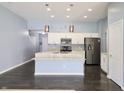 Open concept kitchen with an island, stainless steel appliances, and white cabinets at 10628 Bali Ct, Noblesville, IN 46060