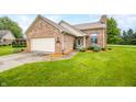 Charming brick home with well-manicured lawn, attached garage and meticulously landscaped entryway at 1105 Sarah Ct, Greenwood, IN 46142