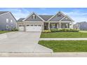 Attractive home exterior with a blend of stone and siding, complemented by green lawn at 1107 Mccray Ln, Westfield, IN 46074