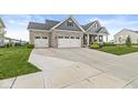 Well-maintained home exterior featuring a three car garage and inviting front porch at 1107 Mccray Ln, Westfield, IN 46074