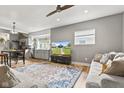 Open concept living room and kitchen with stainless steel appliances, hardwood floors, and a colorful rug at 1205 N Temple Ave, Indianapolis, IN 46201
