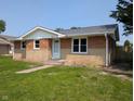 Cozy brick house with a manicured lawn and an inviting entrance at 1359 S Mulberry St, Martinsville, IN 46151