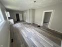 A bright living room featuring modern wood-look floors and neutral walls at 1445 W 34Th St, Indianapolis, IN 46208