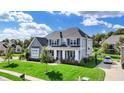 Charming two-story home with gray siding, white trim, and lush green lawn at 14458 Smickle Ln, Carmel, IN 46033
