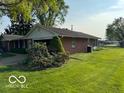 Brick ranch home with well-maintained lawn and landscaping, plus attached garage at 1637 Orchard Ln, Anderson, IN 46011