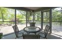 Inviting screened-in porch with wicker furniture, perfect for outdoor dining and relaxation at 17635 Willow Creek Way, Westfield, IN 46074