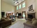 Spacious living room boasts a fireplace, plush seating, and lots of natural light at 2002 Grey Fox Ct, Martinsville, IN 46151