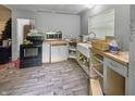 Unfinished kitchen featuring an undermount sink, oven, microwave, and gray cabinets at 2074 W 300 S, Shelbyville, IN 46176