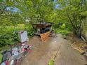 Outdoor patio area with furniture and various objects, surrounded by lush greenery at 2074 W 300 S, Shelbyville, IN 46176