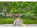 Exterior home view showcasing the inviting entrance with stone steps and beautiful landscaping at 2233 Washington St, Columbus, IN 47201