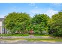 Charming home exterior with mature trees and landscaping at 2233 Washington St, Columbus, IN 47201