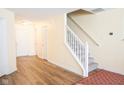 Inviting foyer features a staircase, hardwood floors, and neutral paint throughout the entrance at 2388 Cedarmill Dr, Franklin, IN 46131