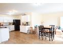 Open kitchen and dining area, featuring white cabinets and modern appliances at 2388 Cedarmill Dr, Franklin, IN 46131