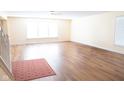 Bright living room features beautiful hardwood floors, neutral paint, and bright, natural light at 2388 Cedarmill Dr, Franklin, IN 46131