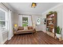 Cozy living room with hardwood floors, neutral walls, and lots of natural light at 2433 E 16Th St, Indianapolis, IN 46201