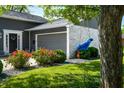 Charming exterior with a tree swing, beautiful landscaping, and a well-maintained lawn at 3701 Sandy Hook Dr, Columbus, IN 47203