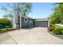 Inviting home with a spacious driveway and attached garage, surrounded by beautiful landscaping at 3701 Sandy Hook Dr, Columbus, IN 47203
