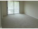 Bright bedroom featuring neutral carpet, light walls and a sliding glass door at 4486 Abby Creek Ln, Indianapolis, IN 46205