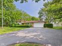 Charming home with a brick and siding exterior, a large driveway, and an attached two-car garage at 4733 E 100 S, Anderson, IN 46017