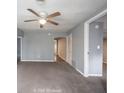 Spacious living room featuring neutral paint, modern fan, and an open layout at 5050 W Regent St, Indianapolis, IN 46241