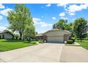 Well-maintained ranch home with long concrete driveway and attached garage at 5215 Limestone Ct, Indianapolis, IN 46237