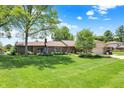 Charming single story brick home with lush front lawn and mature landscaping at 5215 Limestone Ct, Indianapolis, IN 46237